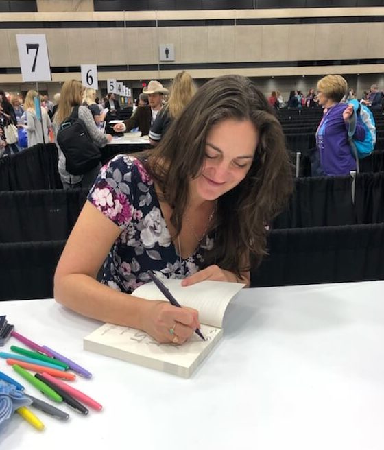 Samantha M Clark signing THE BOY, THE BOAT, AND THE BEAST at TLA 2018.