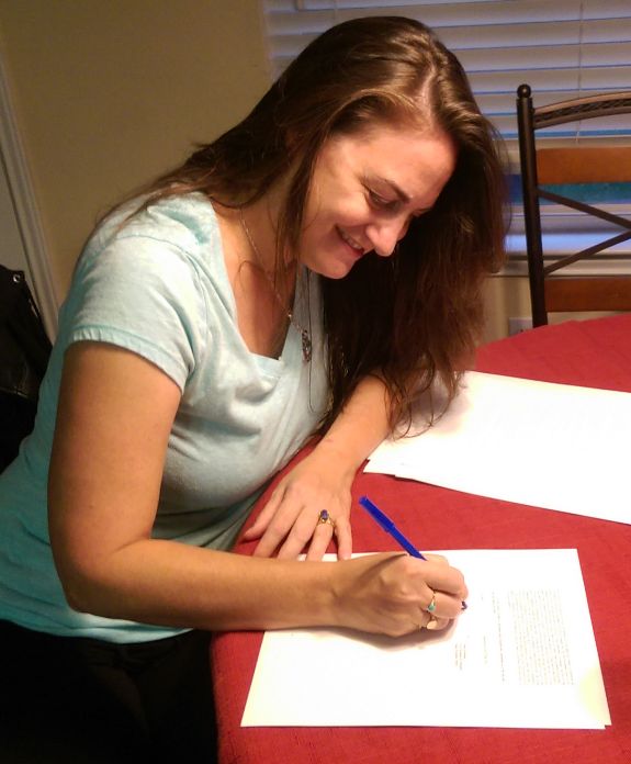Samantha M Clark signing a contract with Simon & Schuster for THE BOY, THE BOAT, AND THE BEAST 